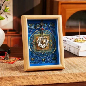 Lotus golden ingot thangka mandala frame with light wood finish and blue mandala artwork, displayed on zen meditation desktop with silver lotus pendant accent
