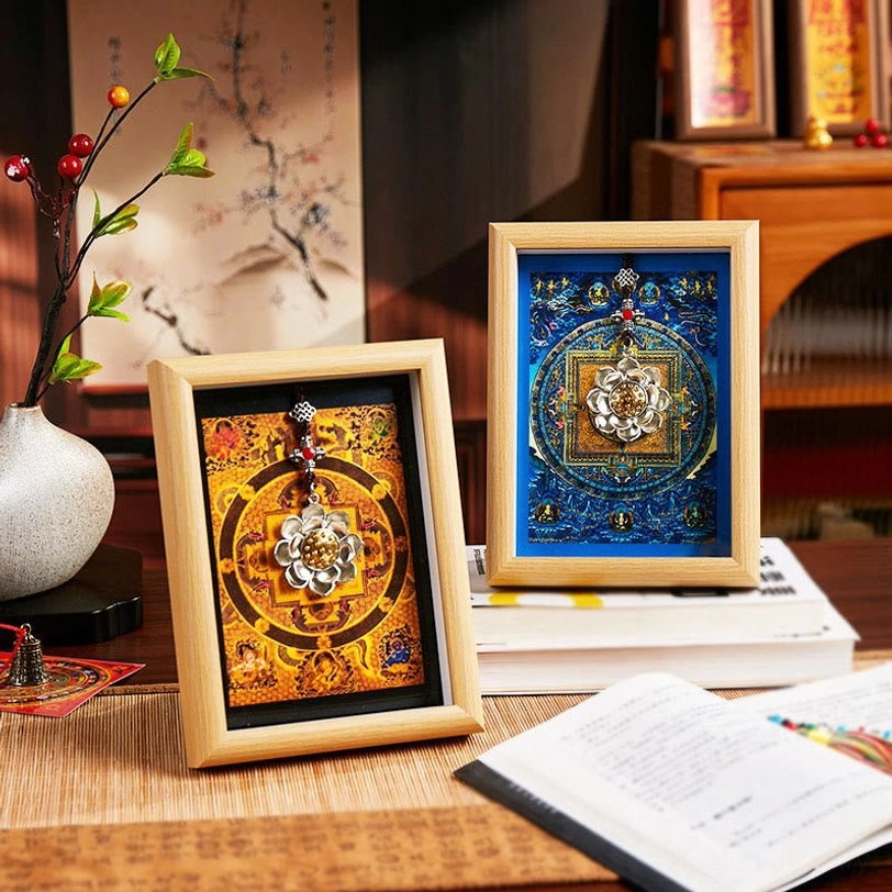 Pair of lotus thangka mandala frames displayed together on study desk, featuring blue and orange mandala designs with decorative vase and book styling