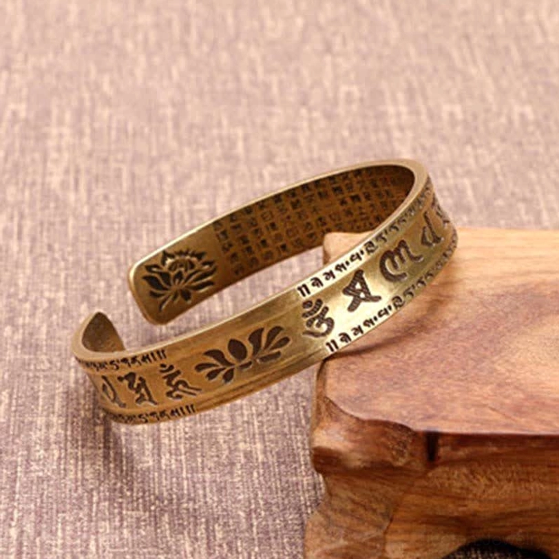 Antique bronze Tibetan cuff bracelet with lotus flower engravings and multiple Buddhist mantras
