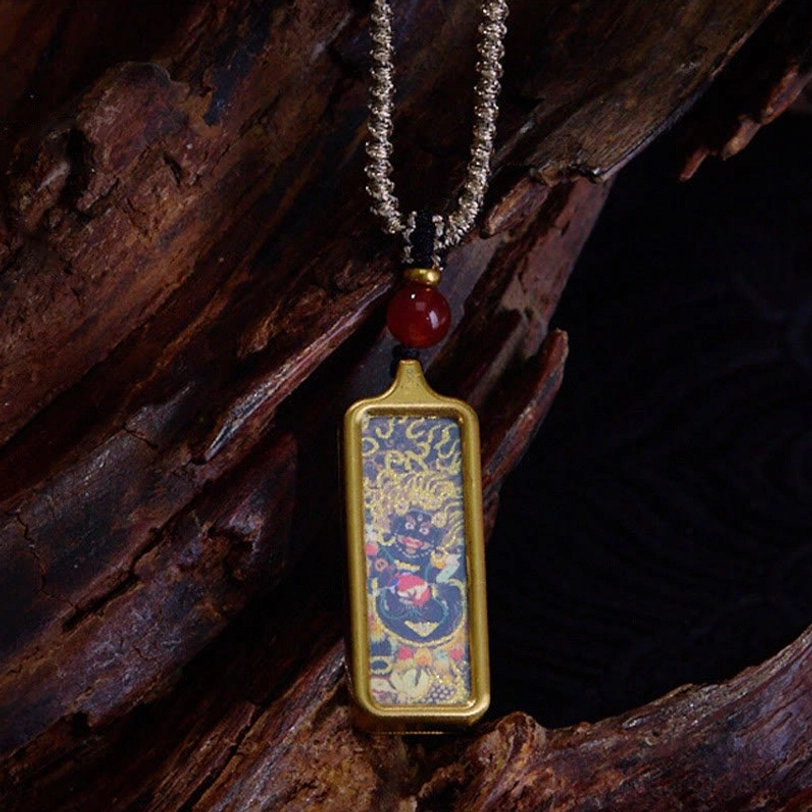 Mahakala wrathful deity hand-painted Tibetan thangka pendant necklace in gold frame with braided silver chain and red agate bead
