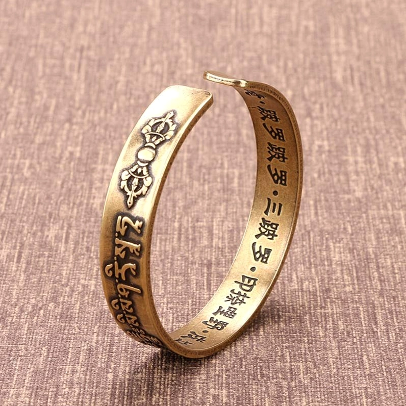Mahāpratisarā mantra open cuff bracelet side view showing Vajra engravings and inner Chinese sutra band