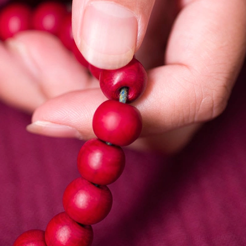 Close-up detailed view of abelia biflora wooden mala beads six-line sacred geometry texture