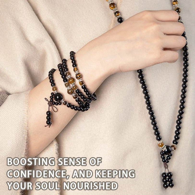 Stacked mala bracelets and long necklace displayed on arm with beige clothing, demonstrating versatile wear