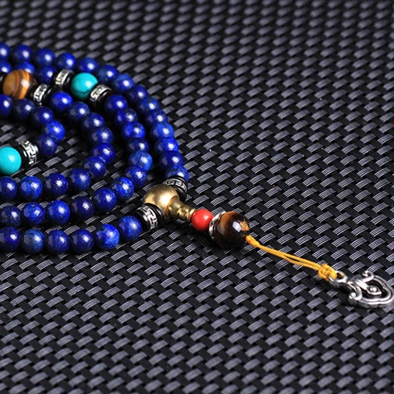 Lapis Lazuli mala bracelet side view showing coiled beads tiger eye accent beads and metal clasp closure