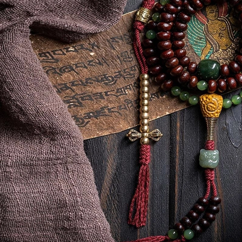 Tibetan mala guru bead with copper dorje pendant and red tassel accent detail