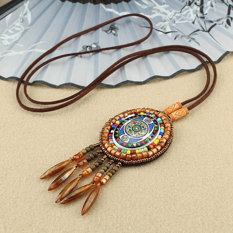 Classic mandala pattern beaded pendant necklace with carved wooden accents and leather tassel decoration
