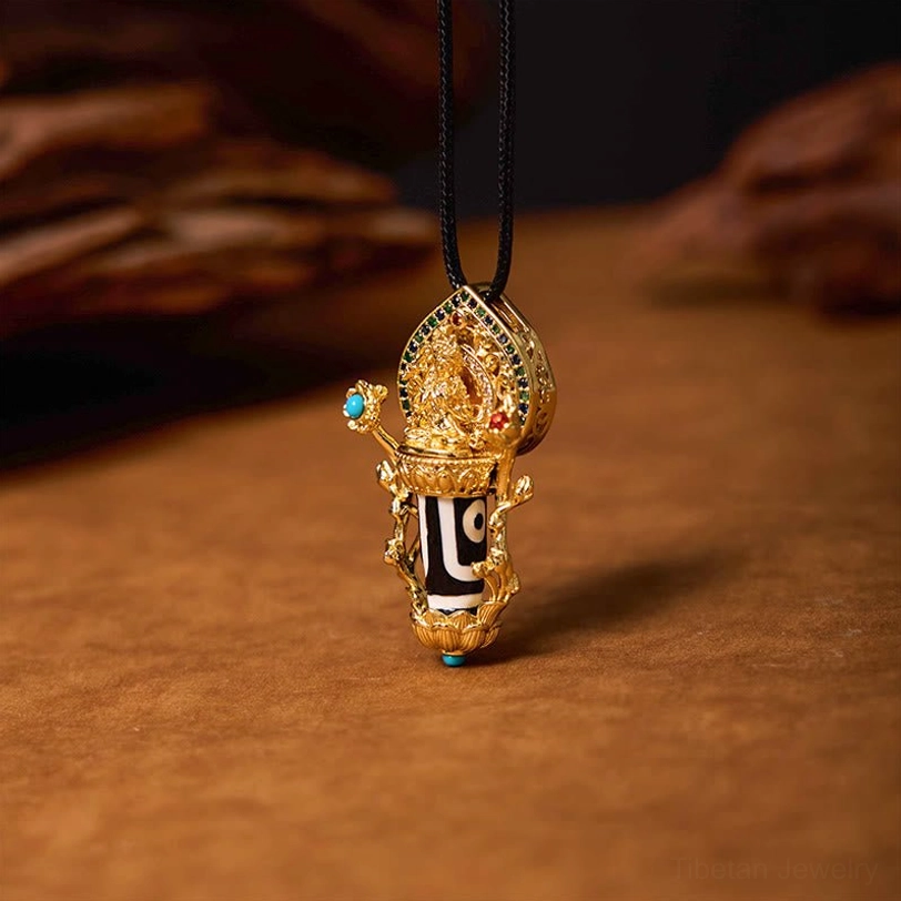 Manjusri Bodhisattva Dzi bead gold pendant necklace with turquoise and red gemstone inlays, front three-quarter view on wooden background