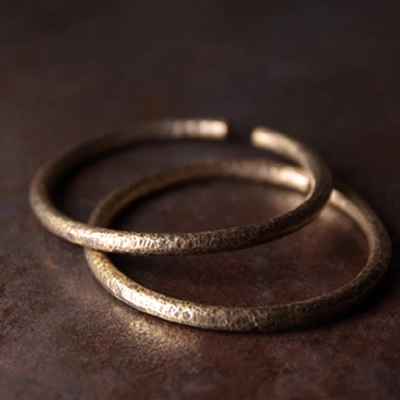 Two matching copper cuff bracelets stacked together, handcrafted antique bronze finish