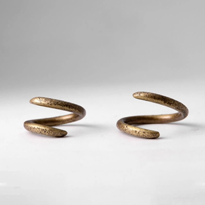 Pair of matching tibetan spiral copper rings flat lay showing antique bronze color and open band design