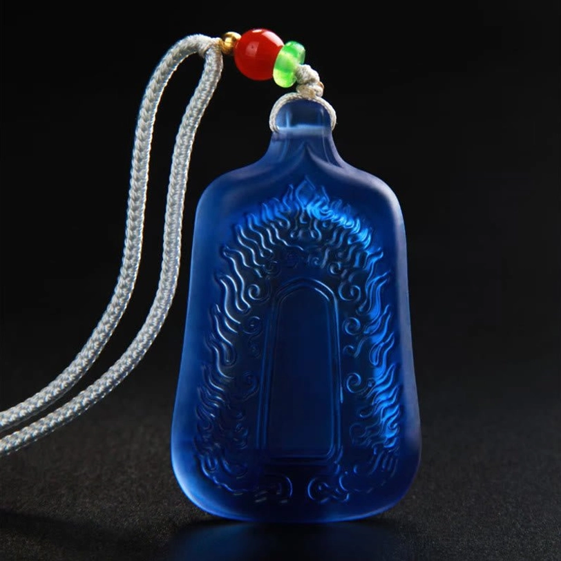 Back view of blue frosted Medicine Buddha crystal pendant showing flame engraved pattern on Liuli glass