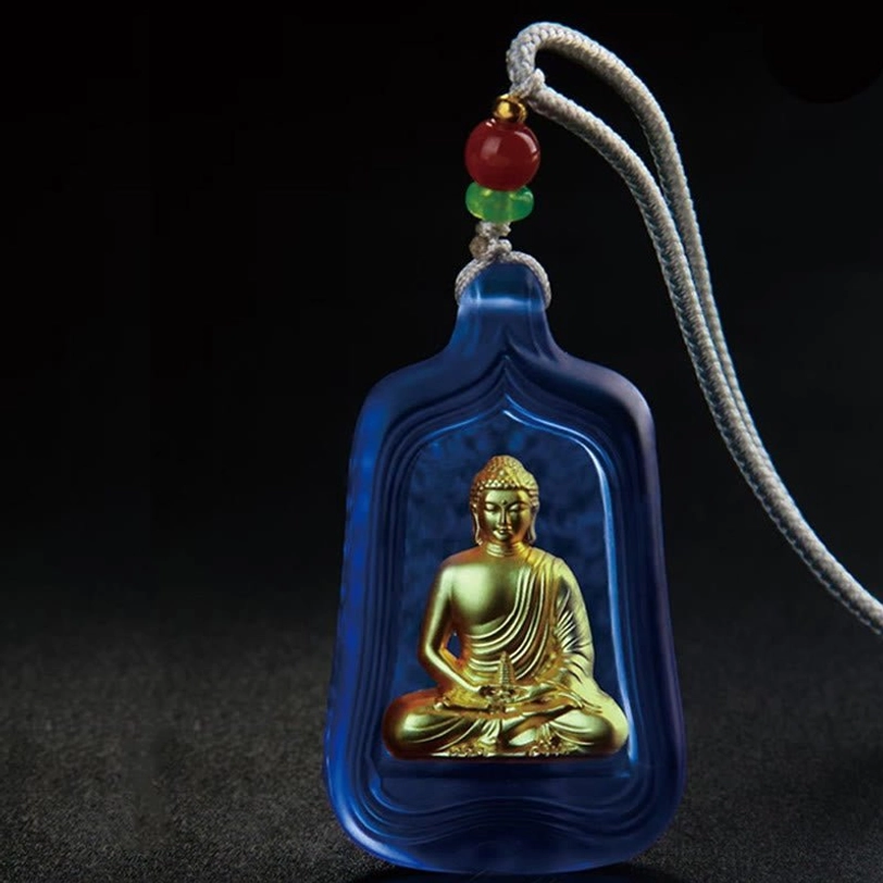 Medicine Buddha Liuli crystal pendant in blue with golden engraved Buddha figure and grey braided cord