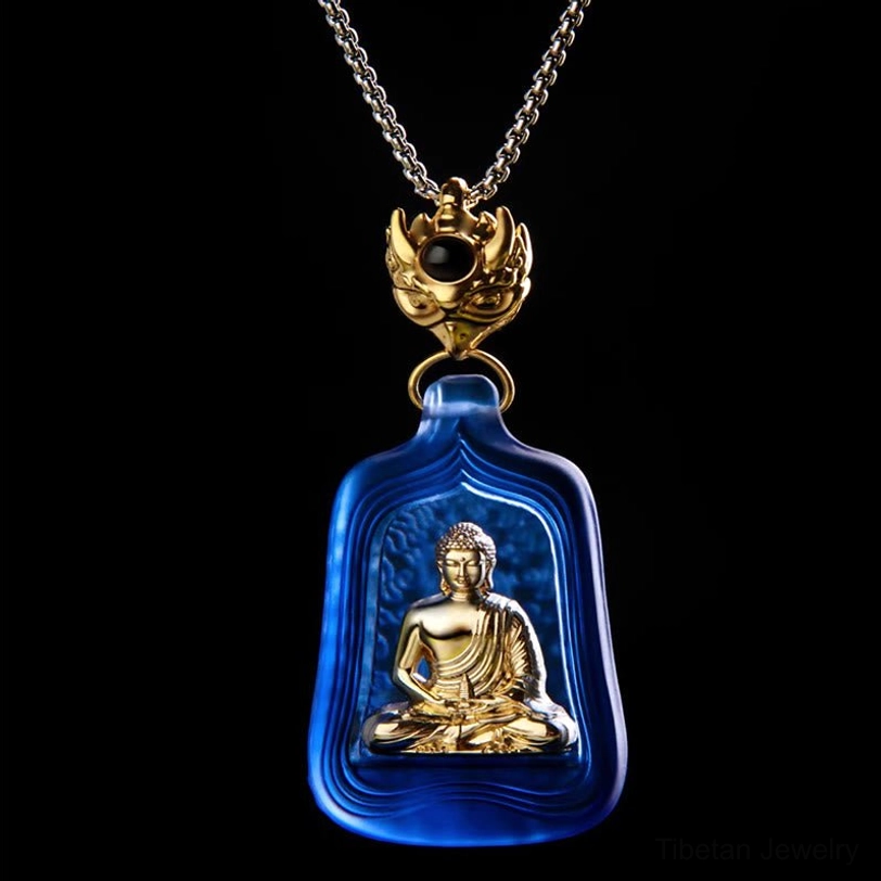 Close-up detail of blue frosted Liuli crystal pendant with golden Buddha and decorative gold clasp with black bead accent
