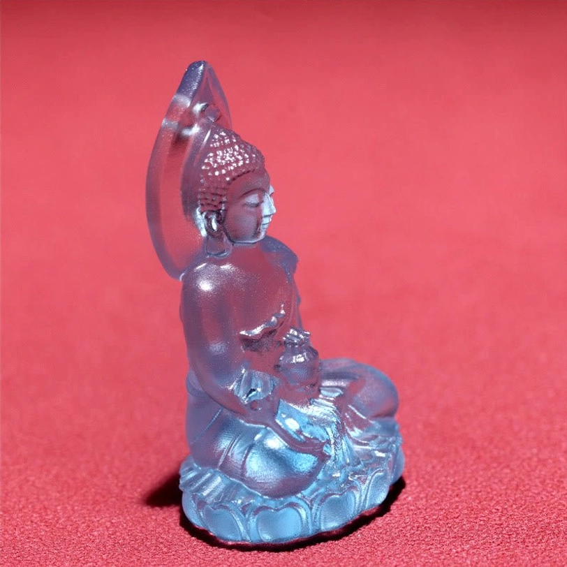Dark blue Medicine Buddha Liuli crystal pendant on woven cord necklace, showcasing deep indigo translucent crystal with metal bail and rope detail
