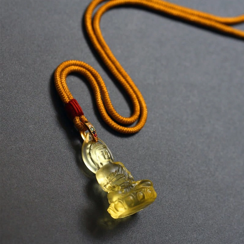 Medicine Buddha pendant handmade Liuli crystal showing texture and translucency, artisanal craftsmanship and unique variations detail