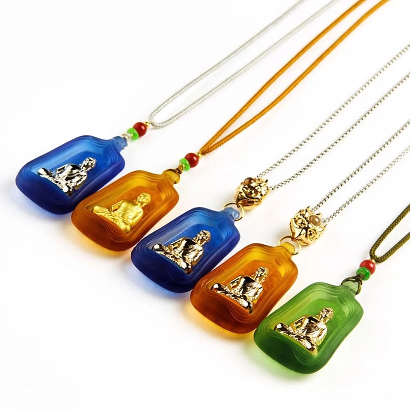 Multiple Medicine Buddha Liuli crystal pendants collection showing blue, amber, and green color options with various chain and rope styles
