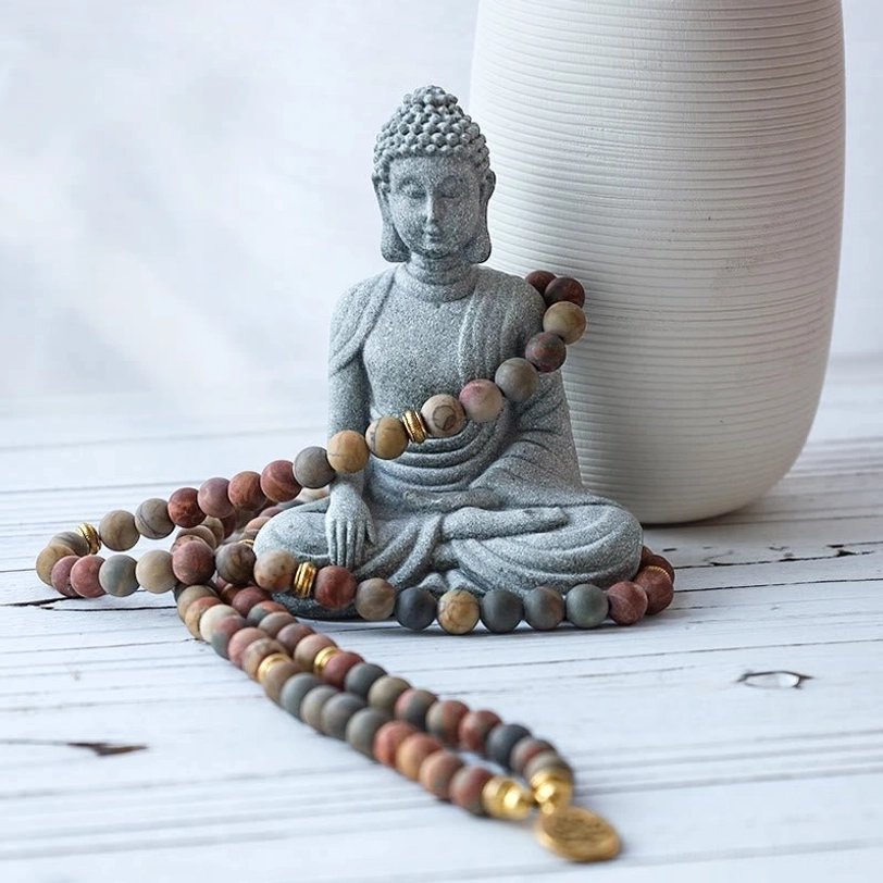 Meditation Buddha statue grey stone sitting pose with draped mala beads ceramic vase decor