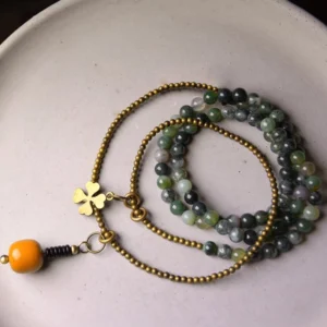 Stacked moss agate and copper multilayer bracelet set flat lay showing vintage brass chain design and mixed natural stone beads