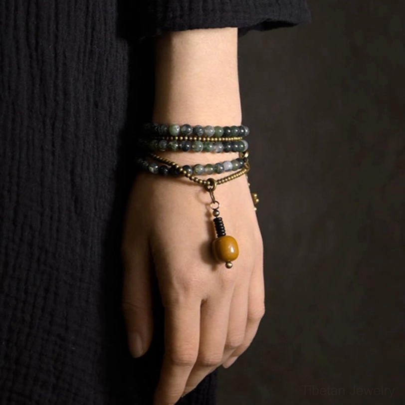 Handmade moss agate multilayer bracelet set stacked on model hand with matching clover charm and natural stone beads