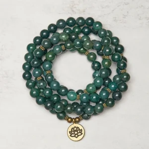 Moss Agate 108-bead Tibetan mala bracelet with golden lotus charm, flat lay view showing polished green agate beads and brass spacers