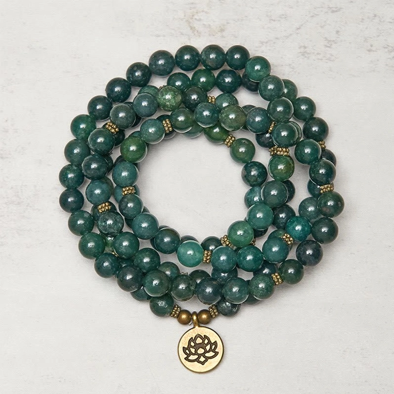 Moss Agate 108-bead Tibetan mala bracelet with golden lotus charm, flat lay view showing polished green agate beads and brass spacers