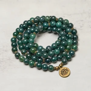 Coiled moss agate healing mala necklace with gold lotus pendant, close-up detail showing natural stone texture and bead polish