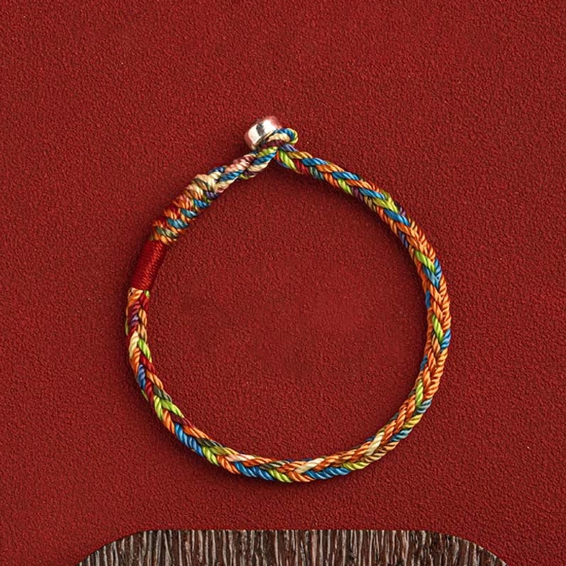 Tibetan King Kong knot multicolored woven bracelet overhead flat lay showing silver metal clasp and complete circular loop