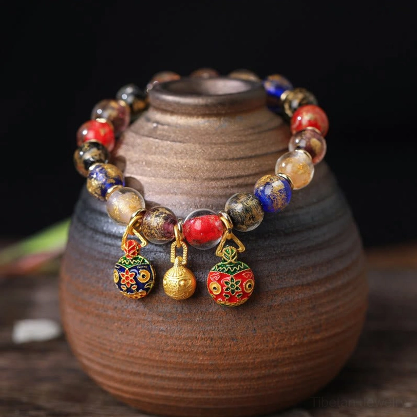Multicolored liuli glass bead bracelet with gold bell and enamel swallowing beast charm
