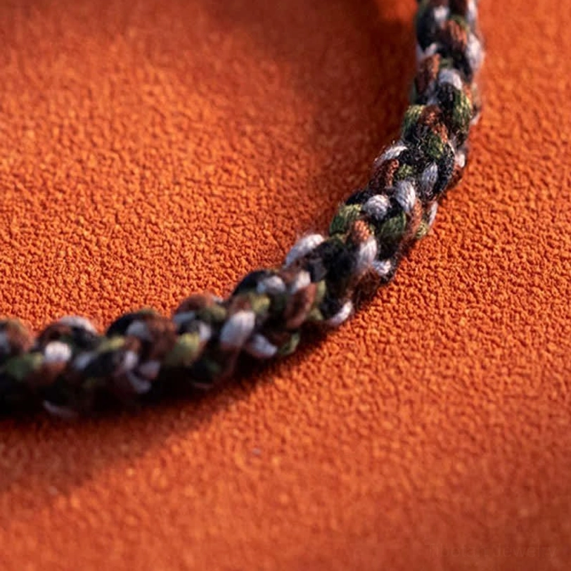 Natural amber bead close-up showing warm golden color, texture, and authenticity of the Tibetan protection bracelet stone