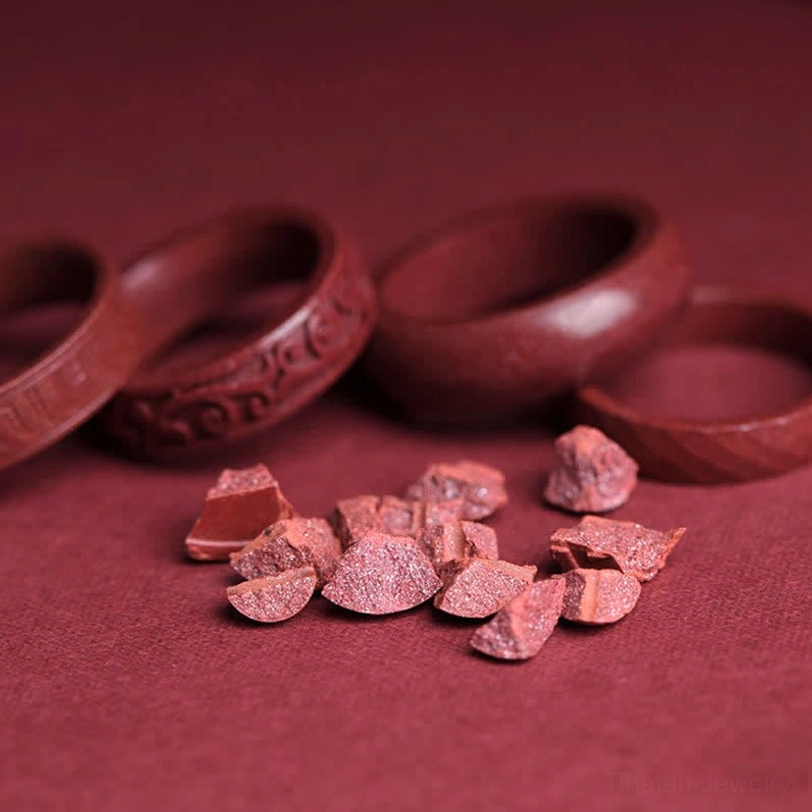 Natural cinnabar stone blessing ring showing authentic granular texture and deep crimson reddish-brown color variation