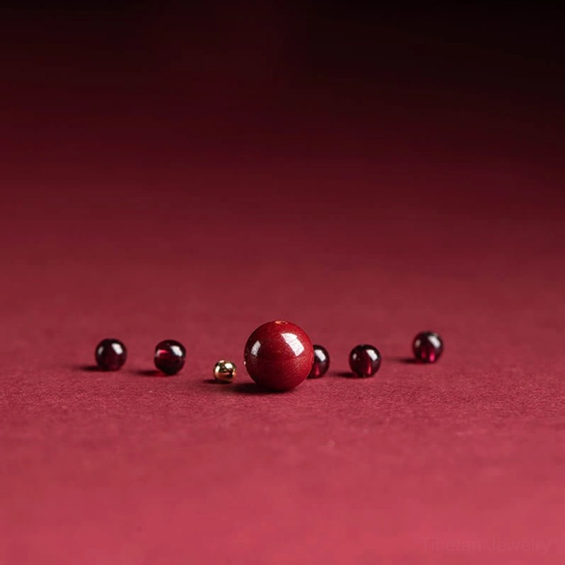 Natural garnet and handcrafted cinnabar beaded ring showing artisanal Tibetan Buddhist jewelry craftsmanship