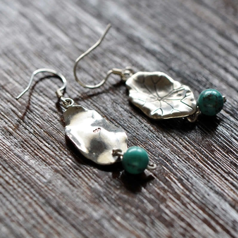 Natural turquoise lotus leaf drop earrings with spiritual symbolism and chakra balancing properties