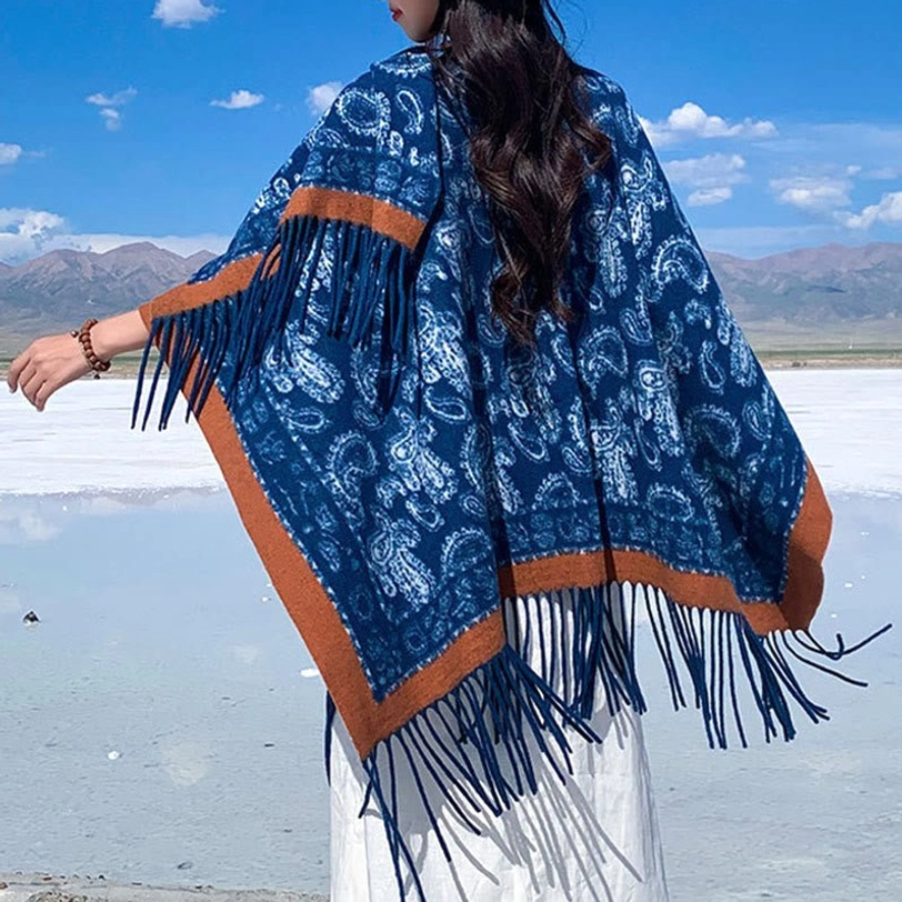 Navy paisley Tibetan shawl with tassel fringe, white geometric patterns on dark blue base, shown in back three-quarter view at alpine salt lake landscape