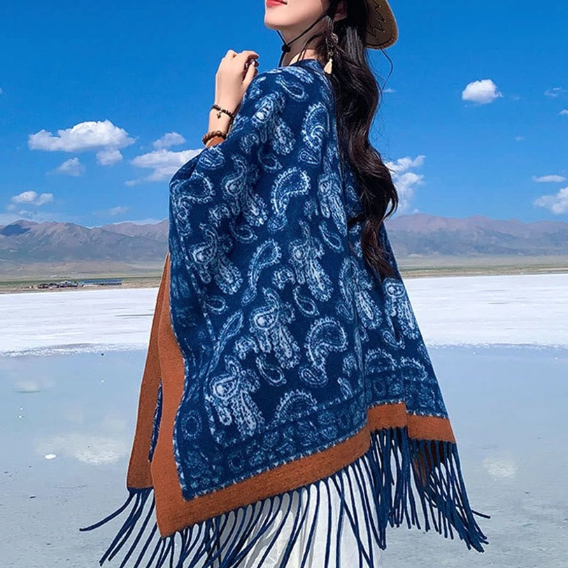 Navy Tibetan fringed paisley shawl with brown border and long tassels, styled with straw hat in outdoor salt lake setting