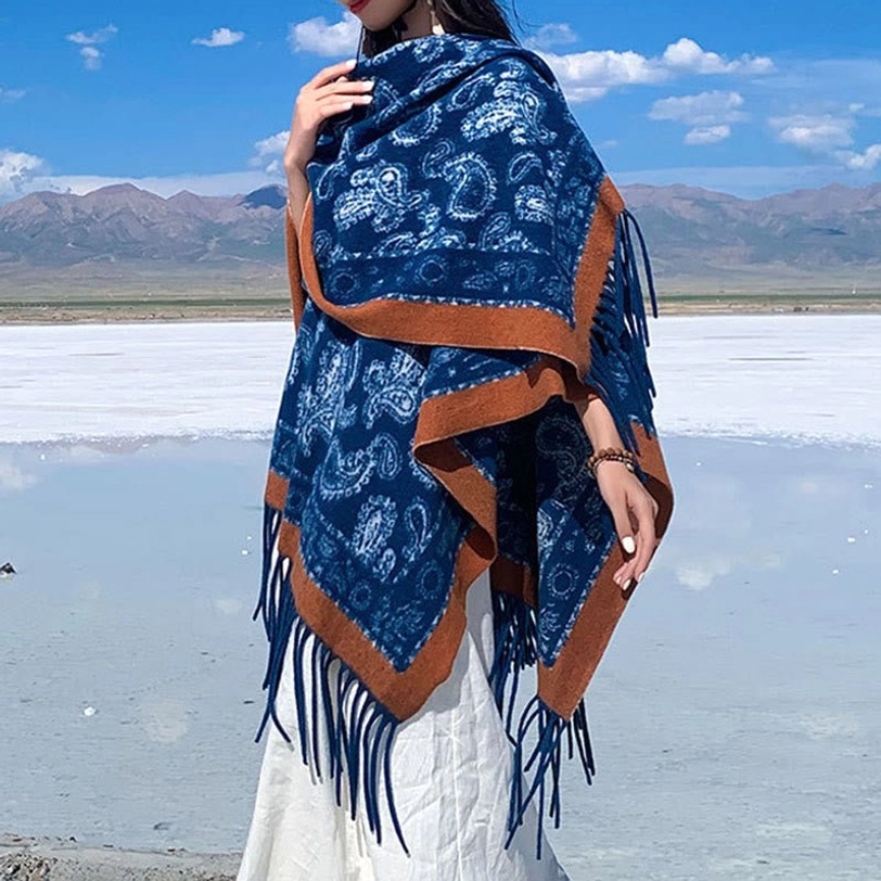 Navy Tibetan shawl with intricate white paisley design and brown trim, jacquard weave shown in side back view at mountain backdrop