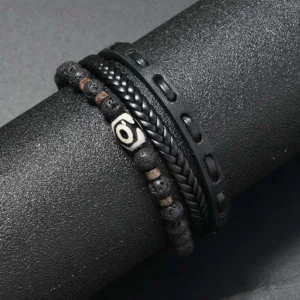 Close-up of black and brown layered Dzi bead prosperity bracelet with lava rock beads on cylinder display stand