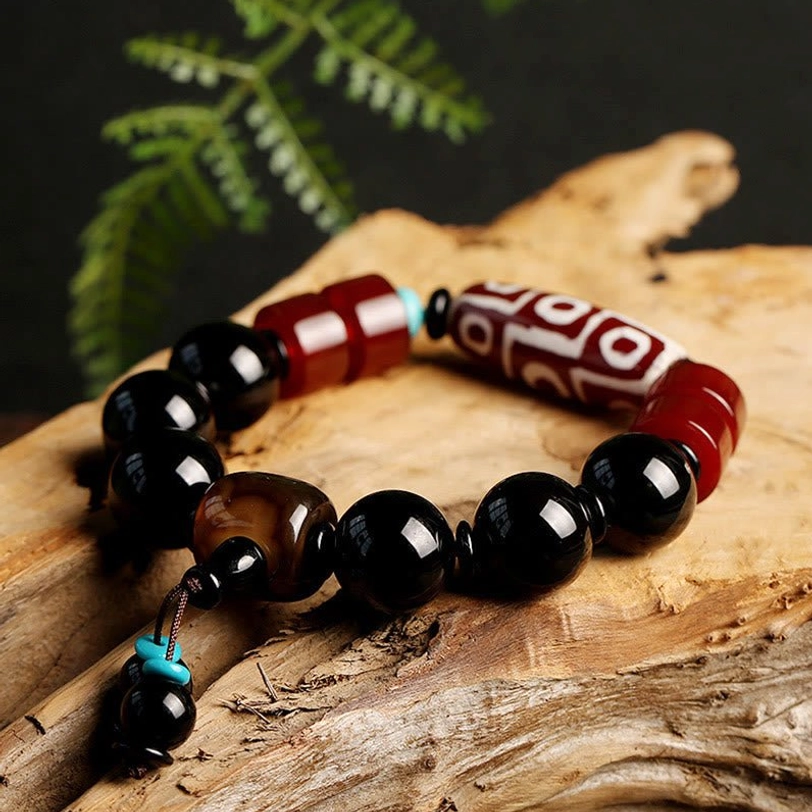 Nine-Eye Dzi Bead Black Onyx Bracelet wrist-worn lifestyle shot - Tibetan spiritual amulet for daily wear, meditation, and protective energy