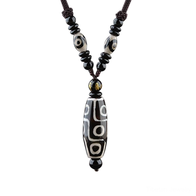 Front-facing nine-eye Dzi bead necklace with detailed hand-painted agate pendant and beaded woven cord, traditional Tibetan wellness jewelry