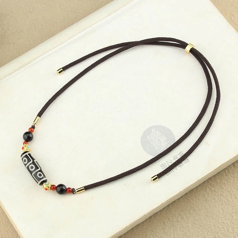 Nine-eye dzi bead necklace neat bead arrangement full pendant display on book cover