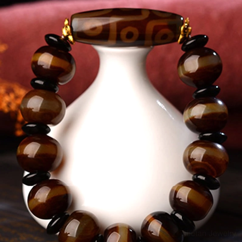 Nine-eye dzi agate bracelet protective amulet featuring handcrafted natural agate beads and traditional Tibetan spiritual symbol