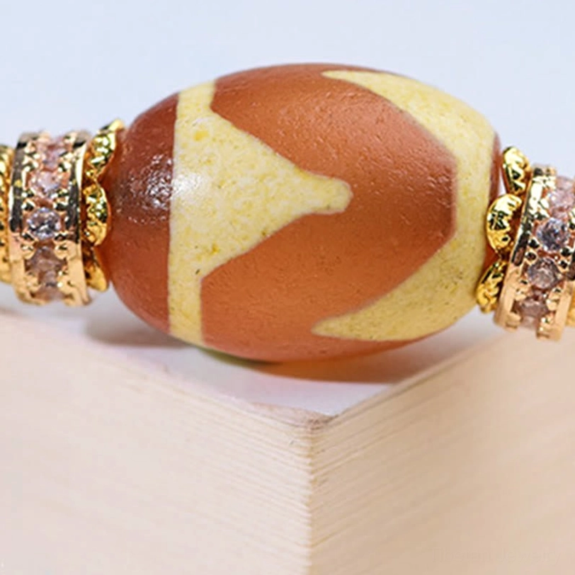 Nine-Eye Dzi bead bracelet lifestyle shot showing wearable spiritual jewelry for daily intention practice