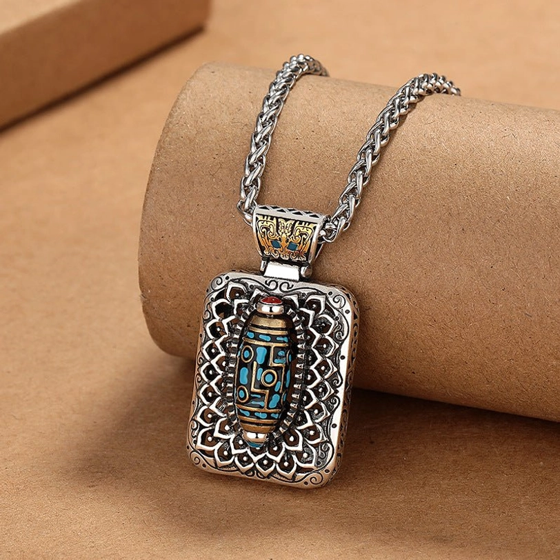 Nine-eye dzi square pendant with red gem accent and hollow carved copper frame detail