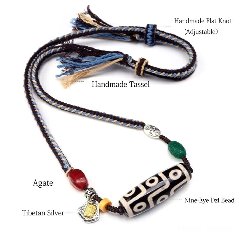 Nine-eye dzi necklace flat lay showing adjustable knot, tassel ends, and all components labeled