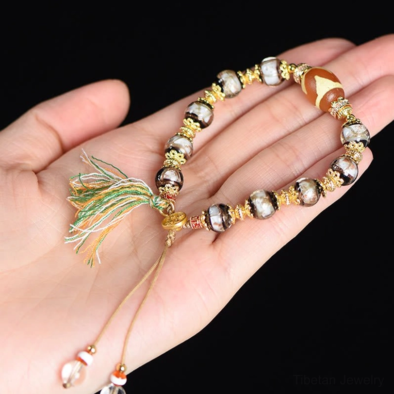 Nine-Eye Dzi bead protection bracelet with elastic cord and artistic tassel styling