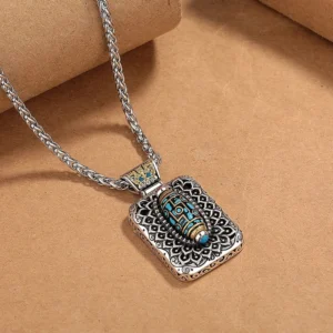 Rotatable nine-eye dzi pendant showing 360-degree rotation mechanism with vintage copper metal finish