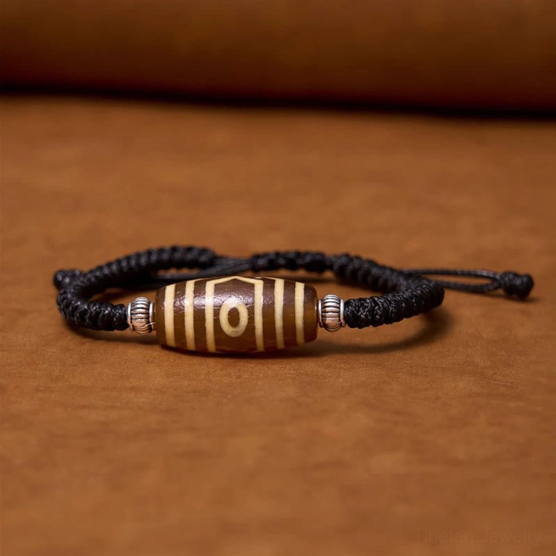Nine-eye and three-eye dzi bead bracelets comparison showing different sacred patterns and spiritual meanings