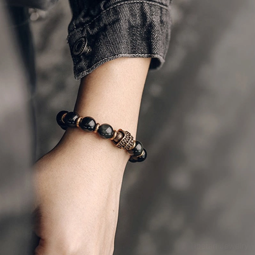 Rainbow obsidian beaded bracelet worn under denim cuff showing casual everyday styling