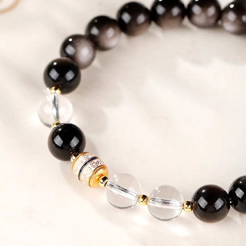 Silver Sheen Obsidian Dzi Bead Protection Bracelet detailed close-up of hand-painted Dzi bead and clear quartz