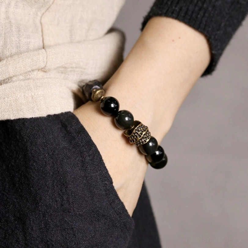 Black obsidian ebony wood copper couple bracelet worn on light skin wrist showing real wearing perspective