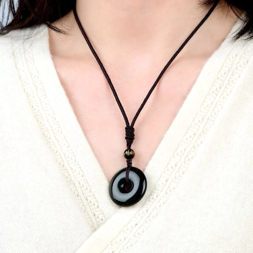 Tibetan obsidian protection necklace worn on neck at collarbone showing adjustable fit and casual daily wear styling