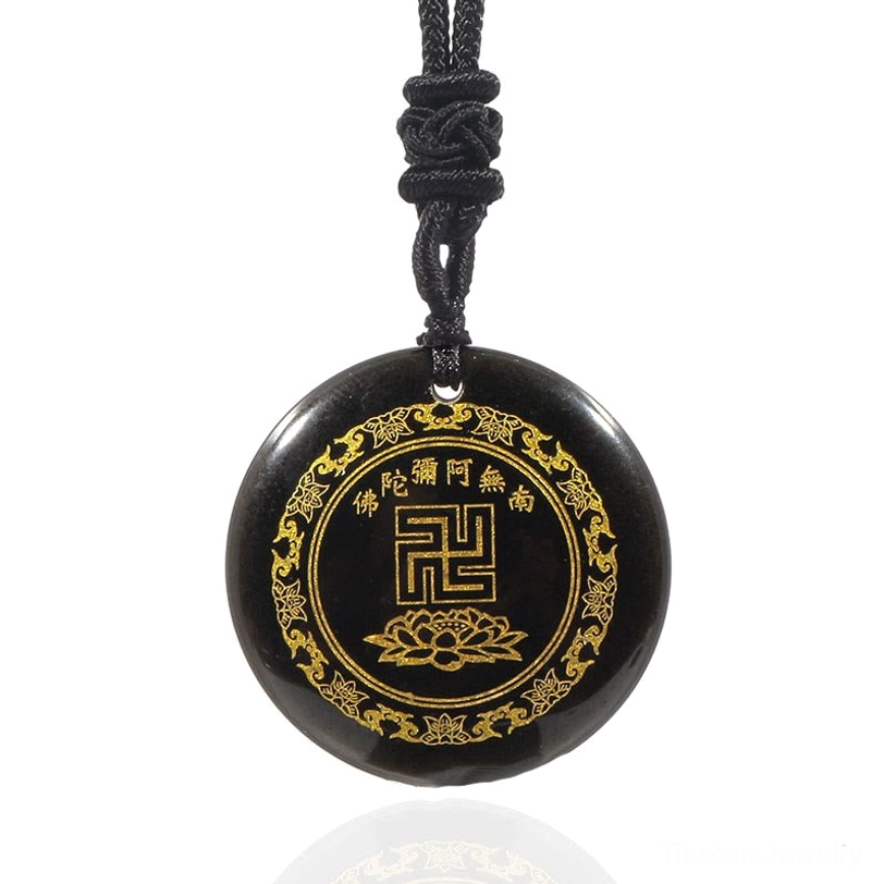 Black obsidian Buddhist pendant flat lay with reflection on white background